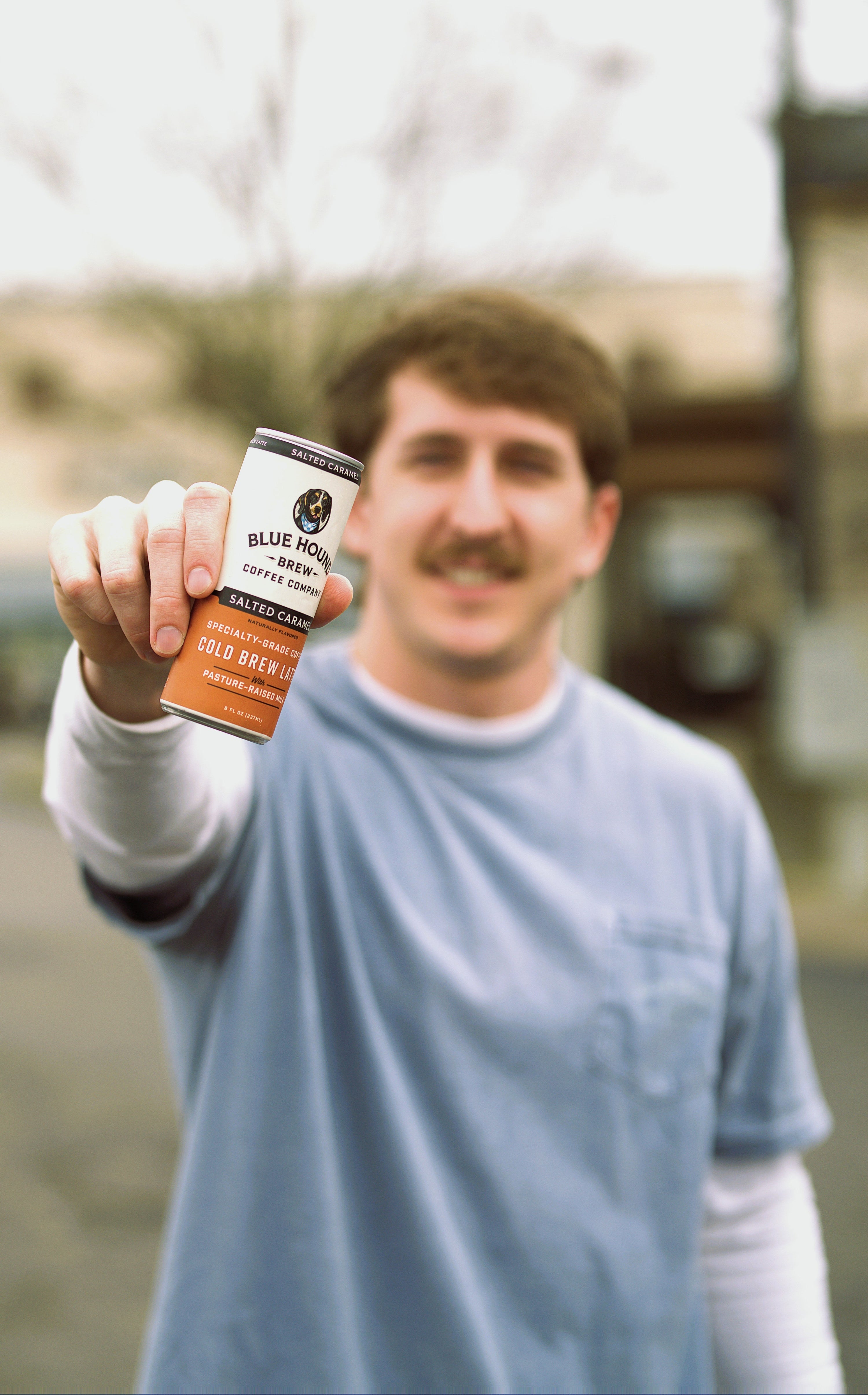 man holding salted caramel cold brew latte